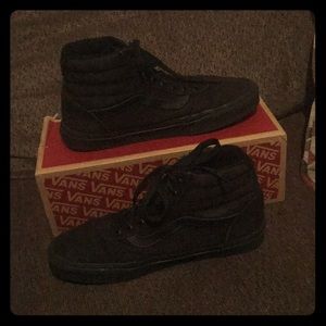 All black hightop Vans Ward shoes.